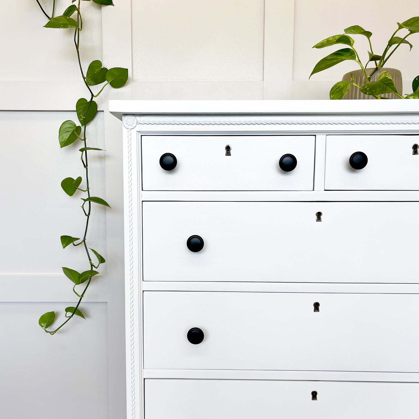 A white antique dresser refinished by ARK Furniture Toronto a sustainable designer furniture store from Toronto, Canada. 