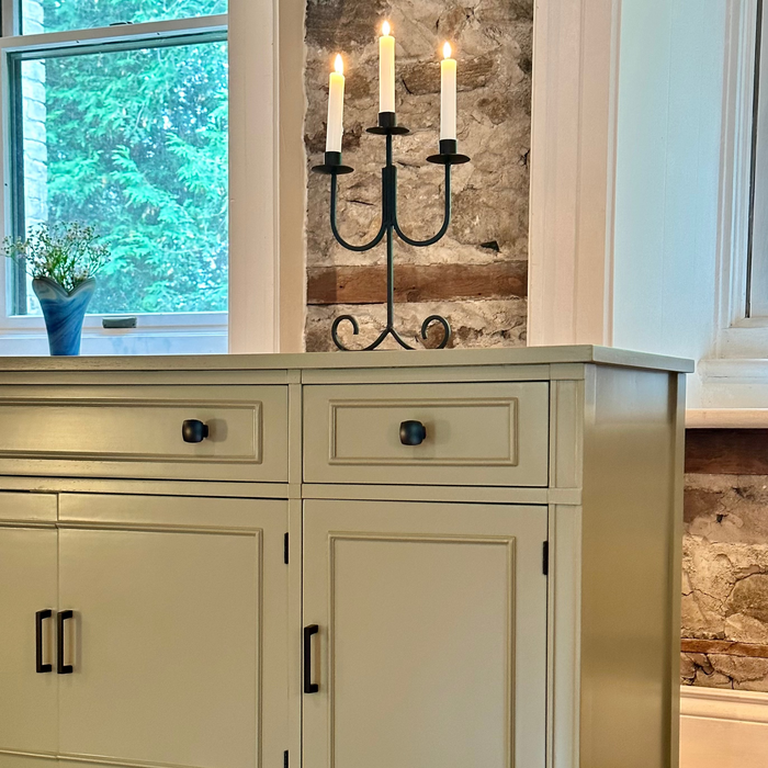 Eucalyptus sideboard with candle holder against a stone wall
